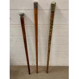 A set of three silver topped walking canes.