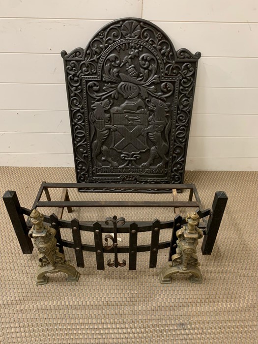 A cast iron fire place back plate, cast with a coat of arms along with grate and fire dogs (H77cm