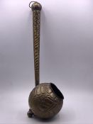 A Hammered antique measure or ladle.