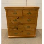 A pine two short over three long chest of drawers with brass handles (H103cm W97cm D46cm)