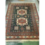 A dark green and red rug with four squares and two square design to center (270cm x 203cm)