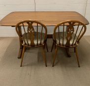 An Ercol table and two Ercol chairs (W152cm D84cm)