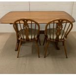 An Ercol table and two Ercol chairs (W152cm D84cm)