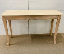 A contemporary console table with stone top