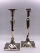 A Pair of Continental silver candlesticks.