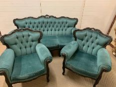 A teal upholstered sofa with scrolled carved shape back and raised on cabriole legs and two