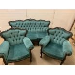 A teal upholstered sofa with scrolled carved shape back and raised on cabriole legs and two