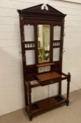 An oak hallstand with tiled back and a centre drawer (H209cm W93cm D33cm)