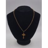 A 9ct gold cross on a 9ct gold chain (7.4g)