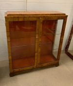 A two door glass display cabinet with two shelves (H100cm W89cm D28cm)