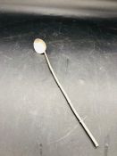 A Silver stirrer, spoon.