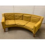 A mid century curved almost 90 degree sofa on oak legs (H70cm W206cm D72cm Seat H34cm)