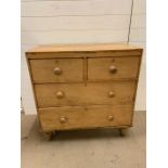 A small pine two short over two long chest of drawers (H86cm W84cm D42cm)