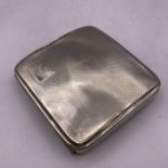 A Machine tooled silver cigarette case with indistinct hallmarks.