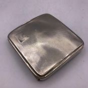 A Machine tooled silver cigarette case with indistinct hallmarks.