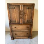 A Berick Oak cupboard with two drawers under (H108cm W68cm D46cm)