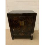 A Chinese black lacquer cabinet, doors decorated in gilt (H85cm W67cm D43cm)