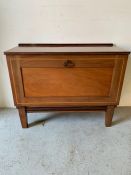 A mahogany satinwood cabinet on legs with hinged dropdown door revealing shelves (H68cm W84cm