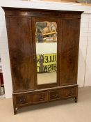 A triple wardrobe with two drawers under and mirror to door