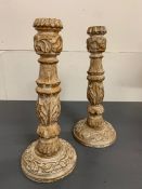 A pair of turned candle sticks with foliage decoration