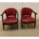 A pair of red leather library arm chairs, upholstered button back on oak tub frame