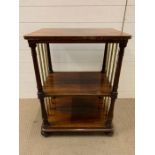 A mahogany two tiered table with brass supports to sides (H82cm W61cm D45cm)