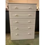 A white modern five drawer chest of drawers