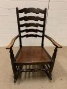 A ladder back rocking chair