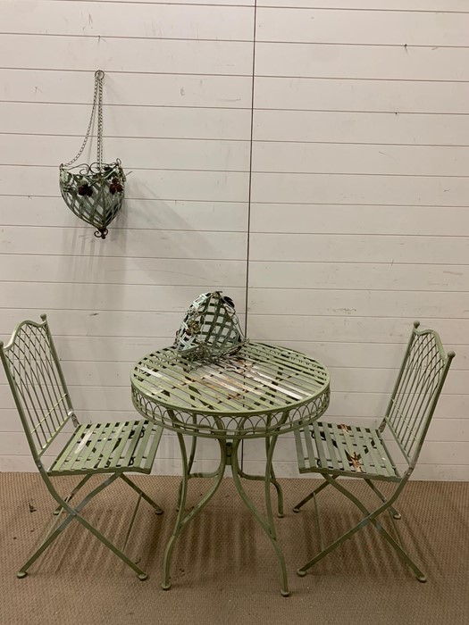 A metal garden Bistro set comprising of a table, two chairs and two hanging baskets