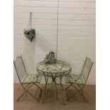 A metal garden Bistro set comprising of a table, two chairs and two hanging baskets