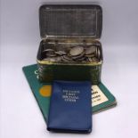 A selection of British pre-decimal coins, including some silver in a parrot boot polish tin and