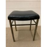 A Stool with black seat pad by Shaw tubular steel furniture.