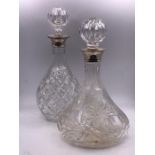 Two Hallmarked silver collared cut glass decanters.