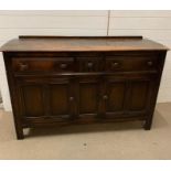 A Ercol sideboard with three drawers and cupboard under (H92CM W145cm D50cm)