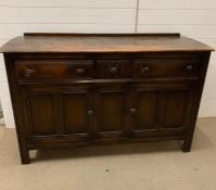 A Ercol sideboard with three drawers and cupboard under (H92CM W145cm D50cm)