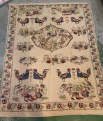 A cream rug decorated with birds and cockerels along with large center medallion (195cm x 151cm)