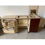 A sewing table complete with a Bernina Matic 910 Electronic sewing machine and sewing patterns.