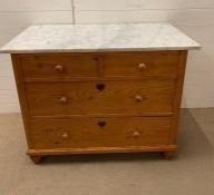 A pine chest of drawers with a marble top, two short over two long drawers (H77cm W100cm D58cm)