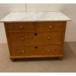 A pine chest of drawers with a marble top, two short over two long drawers (H77cm W100cm D58cm)