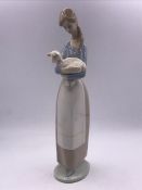 A Lladro figure of a lady with a lamb.