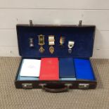 A Masonic case with various jewels, insignia and books.