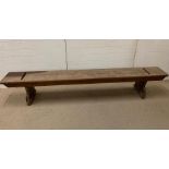 A long wooden bench seat (H43cm W233cm D31cm)