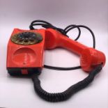 An Orange Vintage Chicco phone.