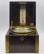 A brass bound mahogany marine chronometer, with lacquered brass gimbal mount and silvered Roman dial