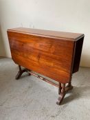 Victorian mahogany double drop Sutherland table on turned gateleg and twin pillar end supports