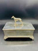 A silver plated cigar box surmounted by a cast Whippet dog and cedar wood lining interior, raised on