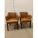 A Pair of Tan Leather padded leather armchairs