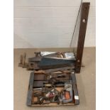 A selection of vintage push me, pull me saws, carpentry tools including plains and hammer drill