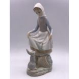 A Lladro Figure of a girl with a rabbit