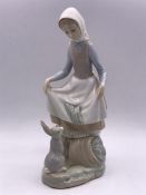 A Lladro Figure of a girl with a rabbit